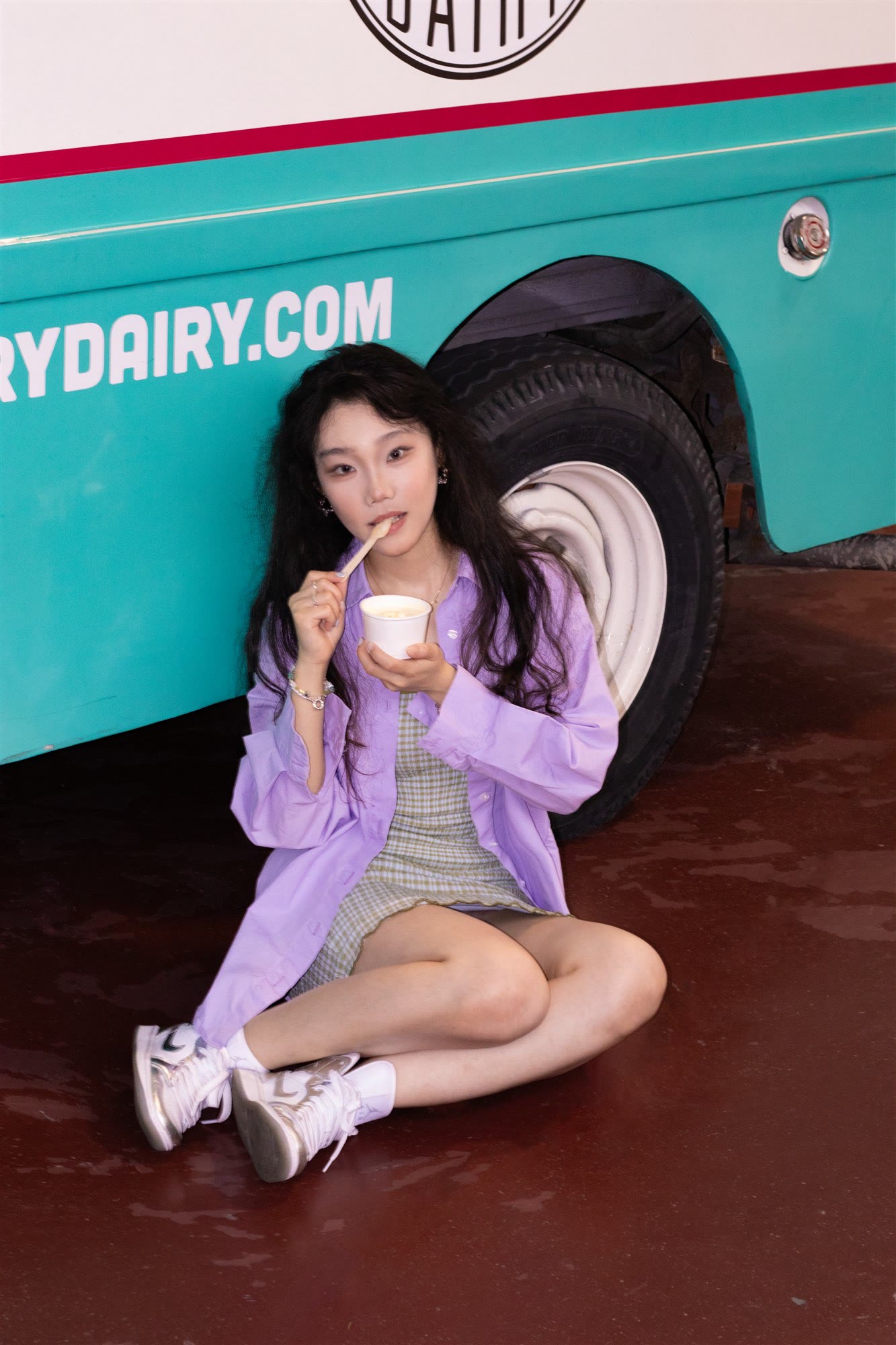 Colourful editorial portrait beside a retro dairy truck